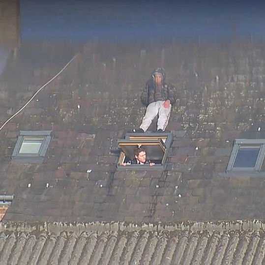 Man tries to avoid police officer by hiding on velux window Man tries to avoid police officer by hiding on velux window