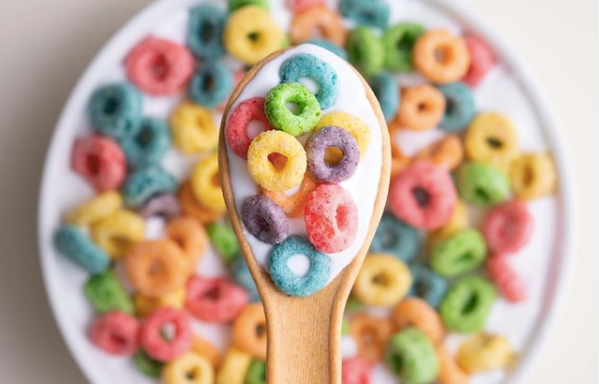 edible spoon being used with colourful cereal loops