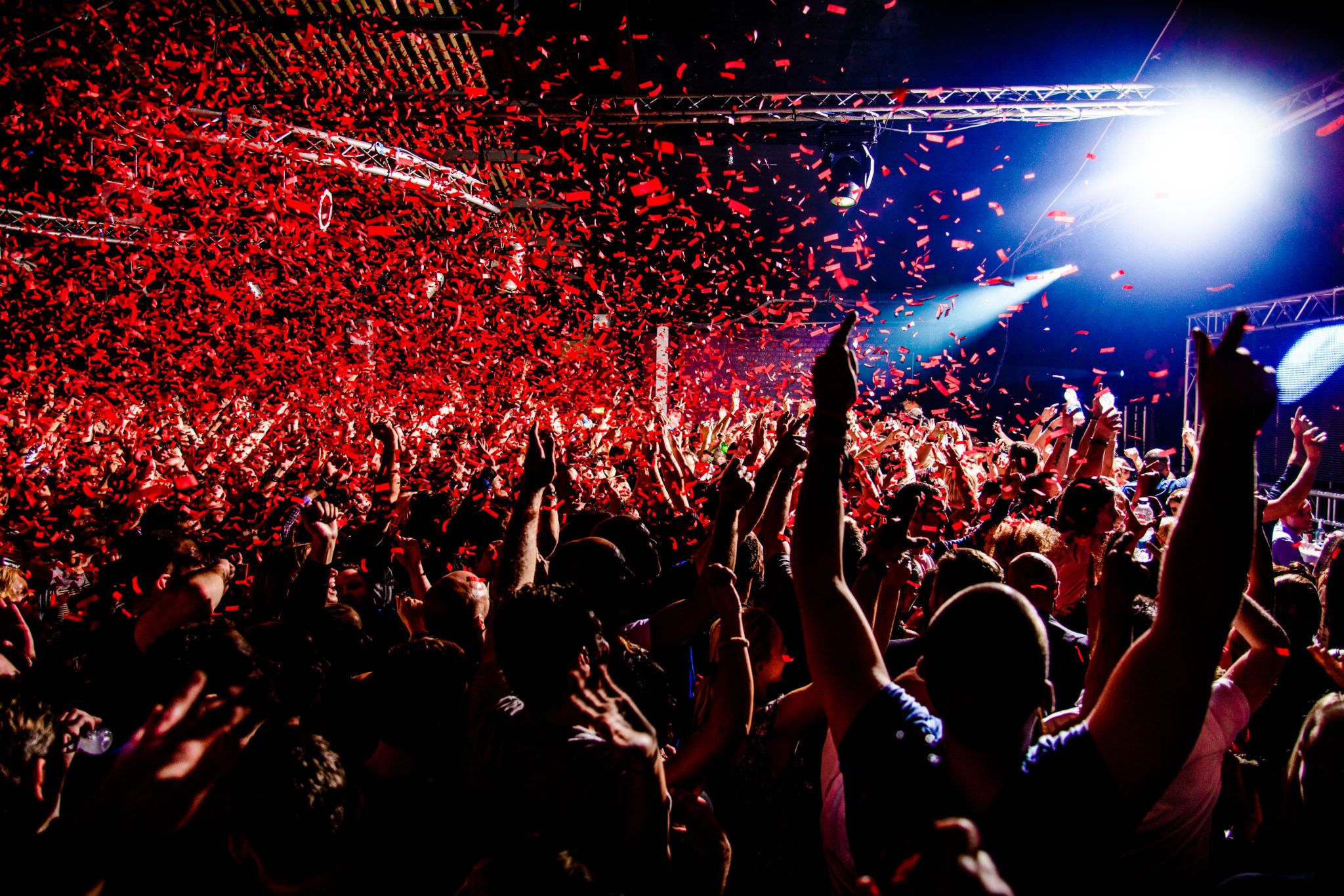 Interior of a nightclub, red confetti falling from the sky