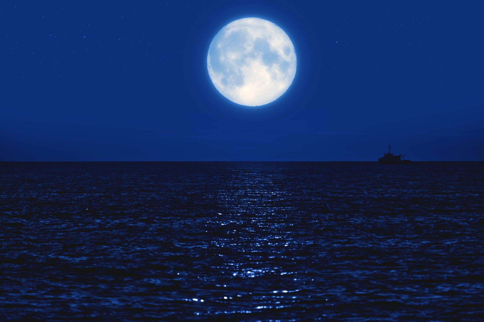 full moon at sea, reflecting on the water
