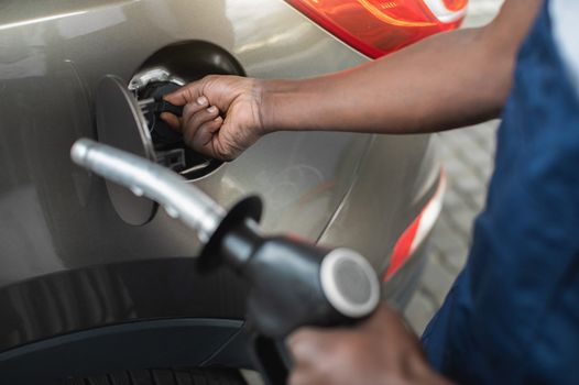 person holding a diesel pump, ready to put it into car
