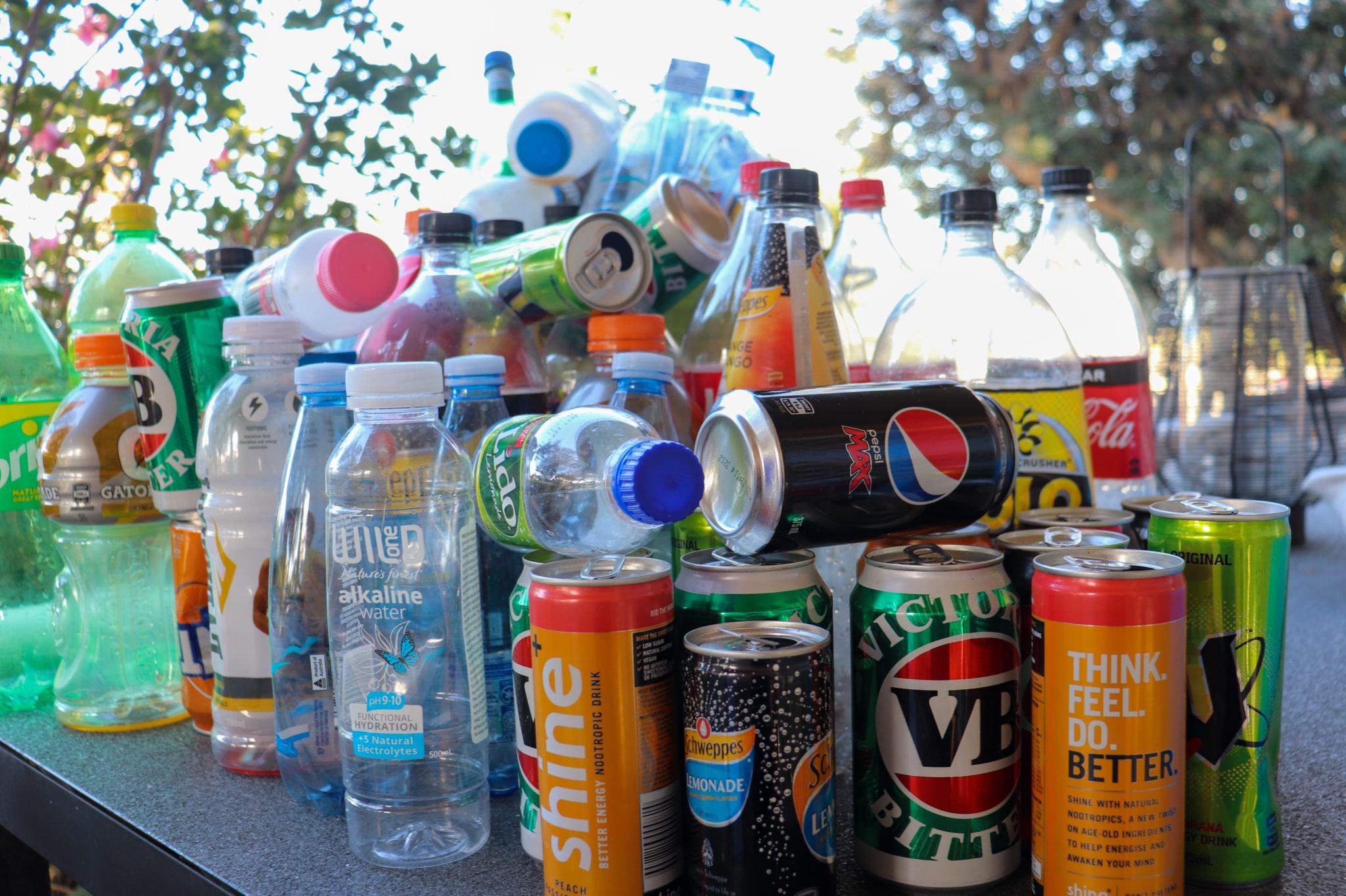 array of used cans and plastic bottles