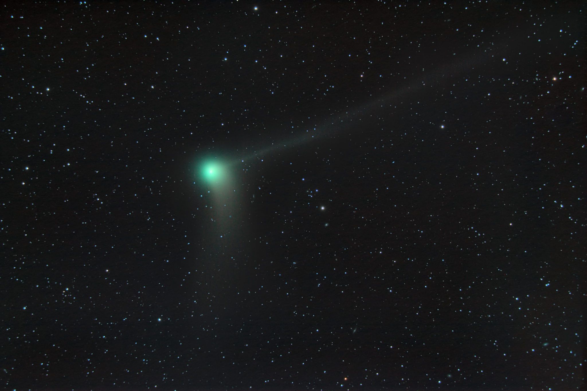 green comet in a night sky